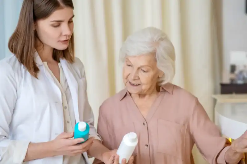 Medical professional talking to a patient about Skin Care Resources holding skincare products